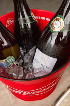Elegant white wine bottles chilling in an ice bucket on a modern table.