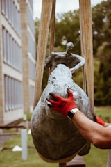 A professional team carefully packing a sculpture for transport.