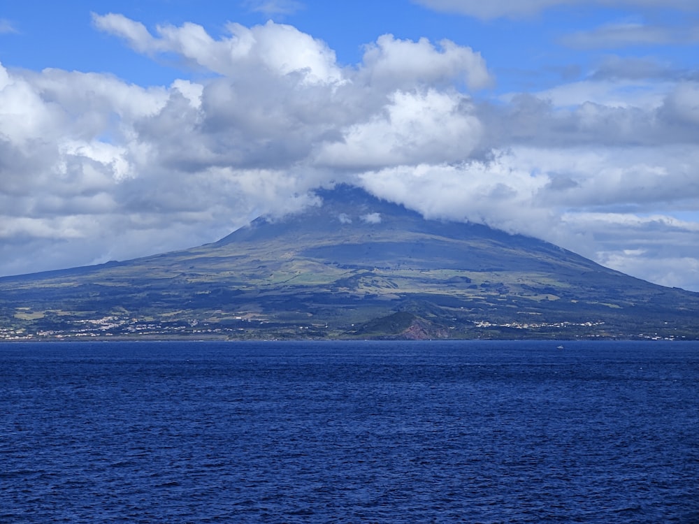 a large body of water with a mountain in the background