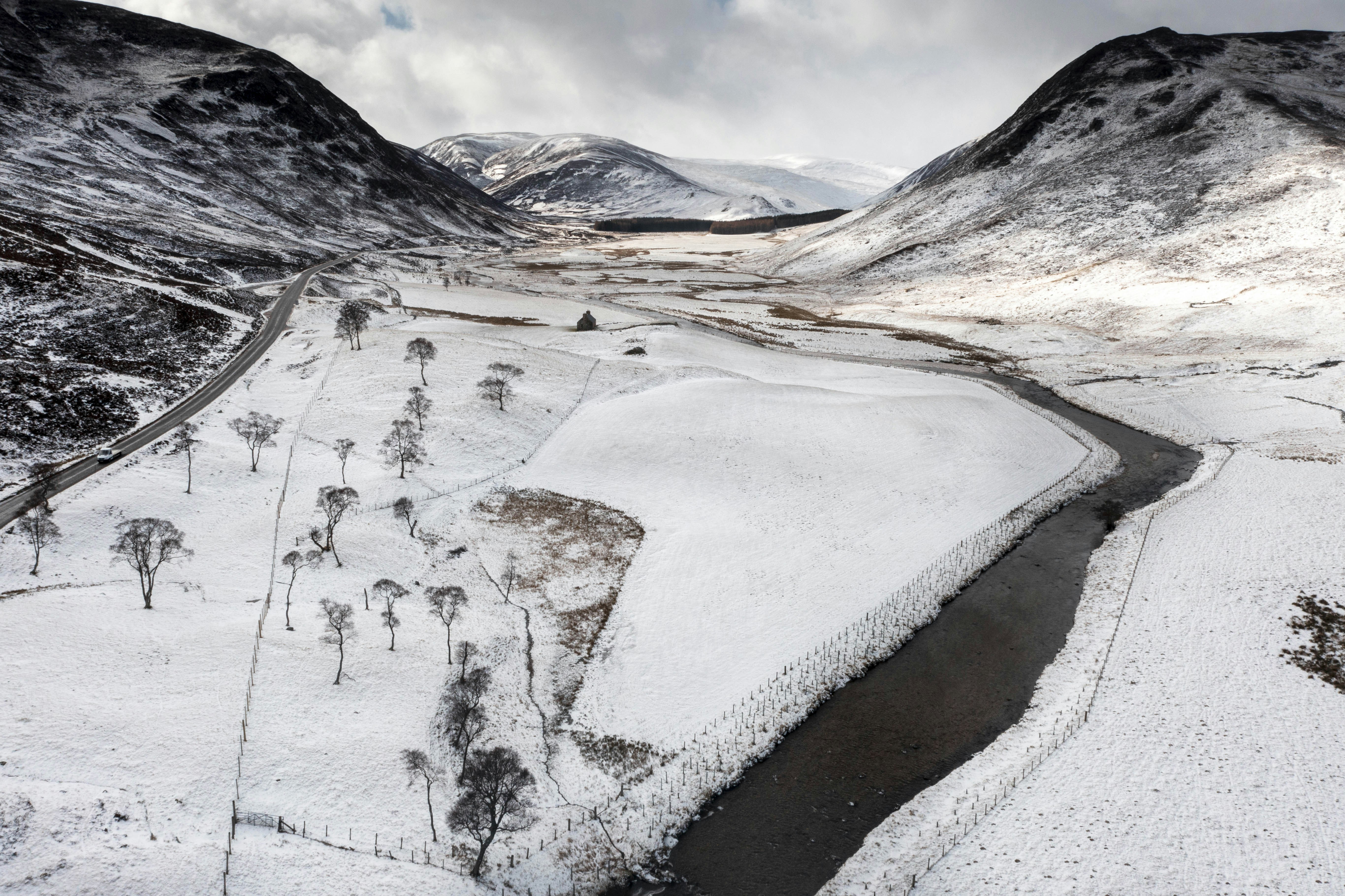 A river running through a snow covered valley photo – Free Glenshee ...