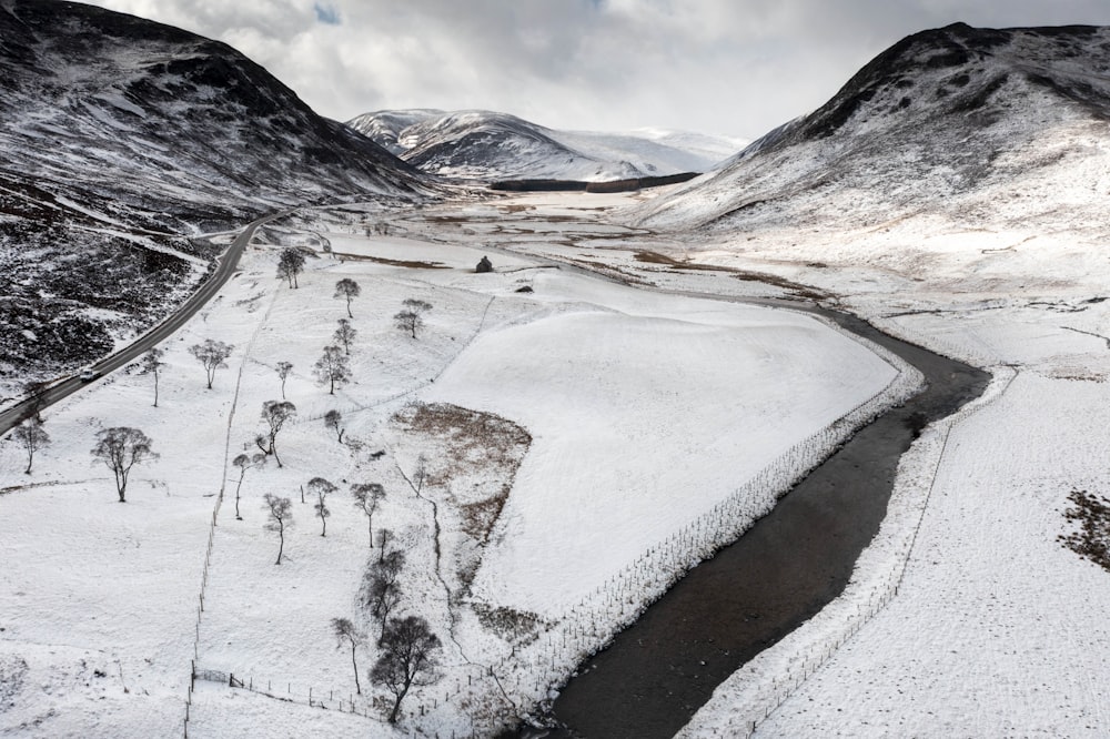 a river running through a snow covered valley