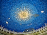 a blue ceiling with a starburst in the middle of it