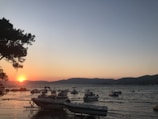Sunset view over a peaceful Búzios beach with boats anchored nearby