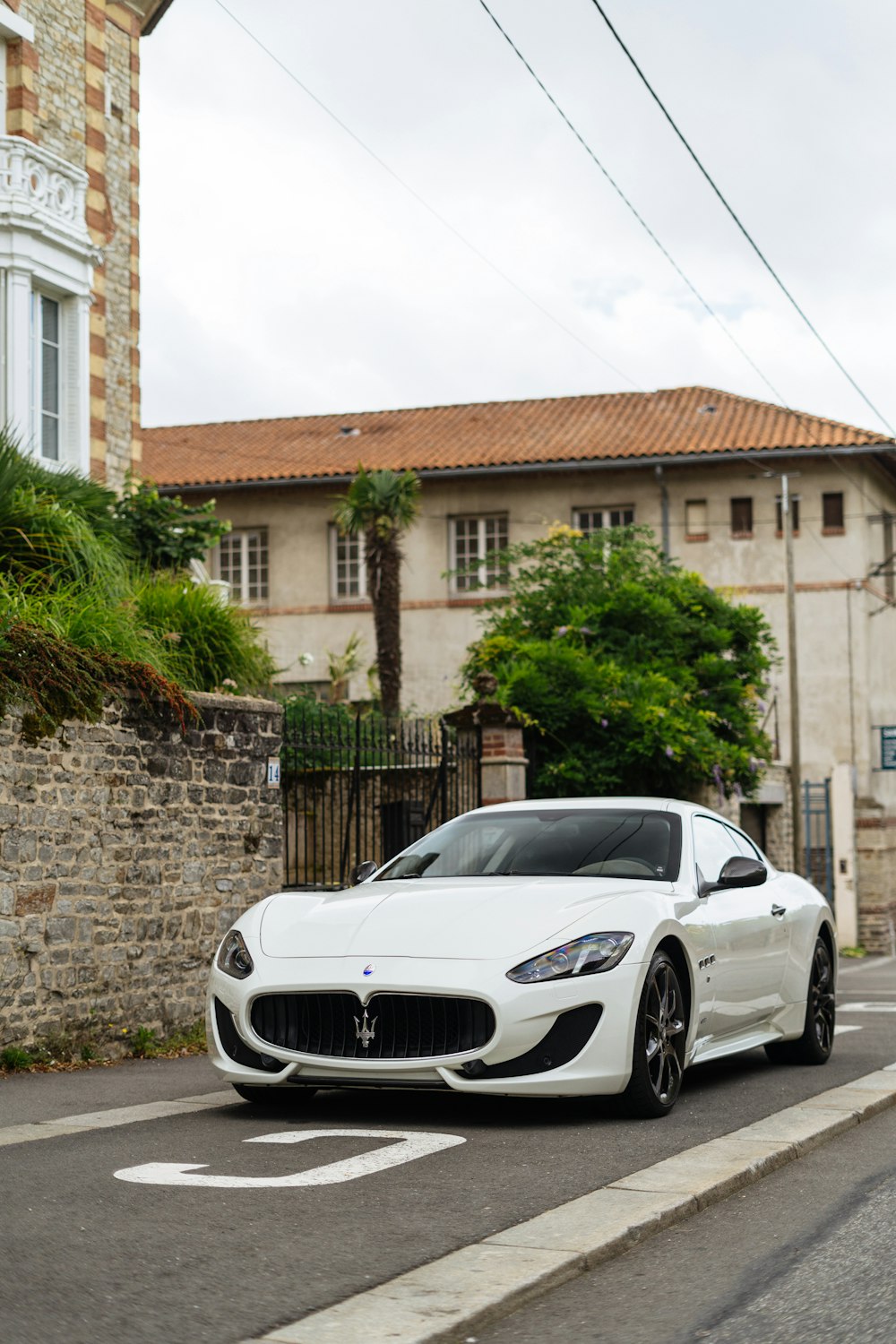 a white masera parked on the side of the road