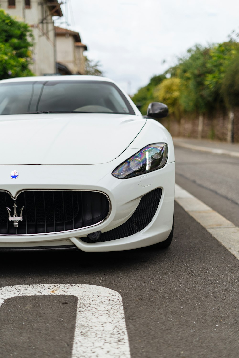 a white masera parked on the side of the road