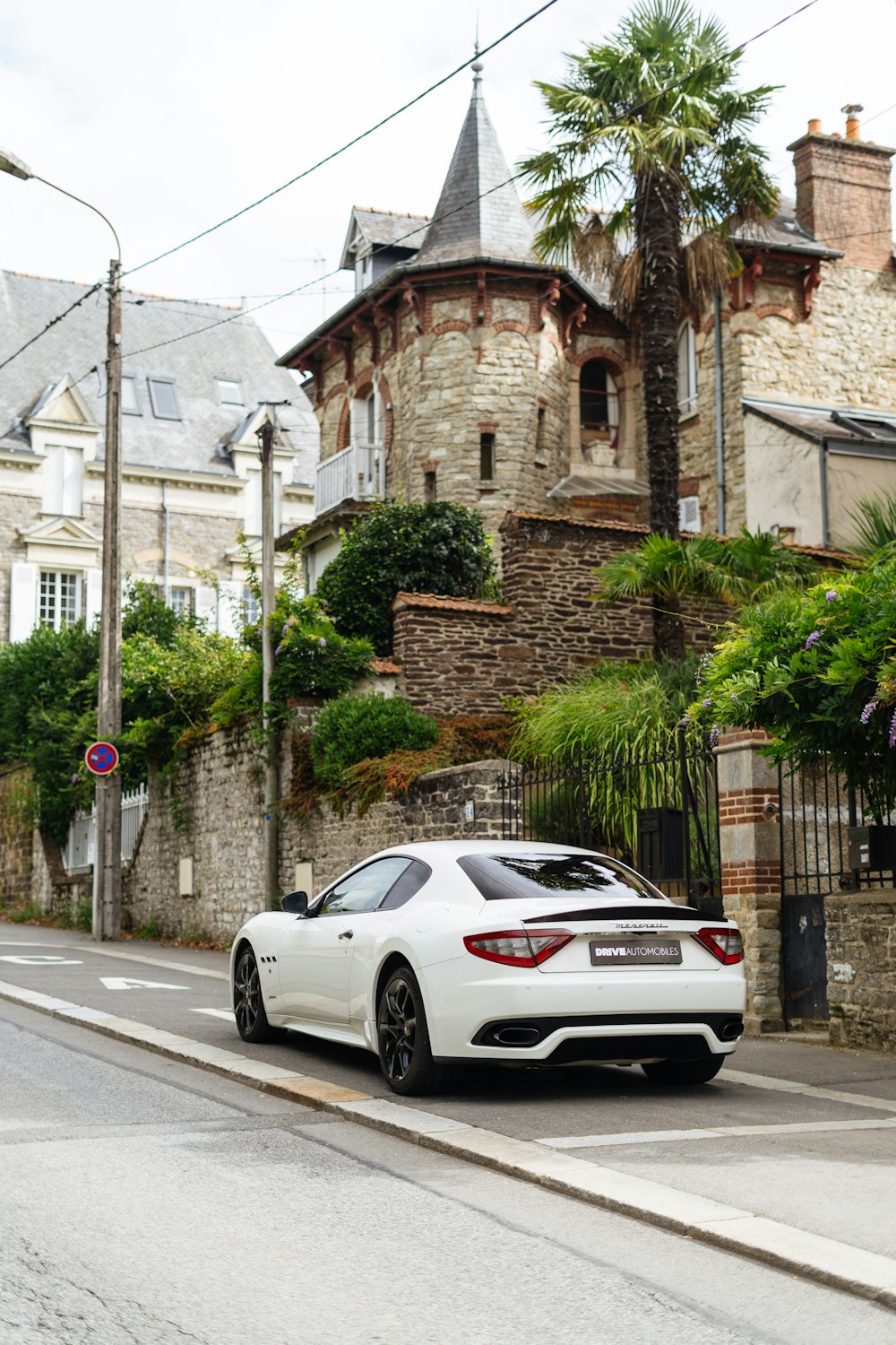 a white car parked on the side of the road