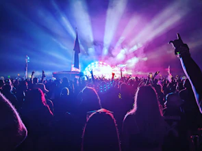 Crowd enjoying live music at the Cape Tormentine Beach Music Festival under colorful stage lights.