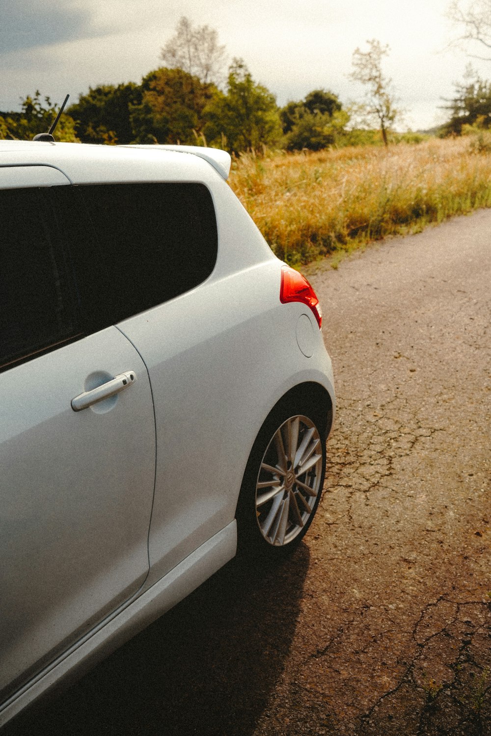 a white car parked on the side of a road