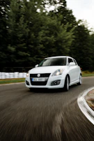 Suzuki Wagon R captured in motion on a winding mountain road, highlighting its agility.