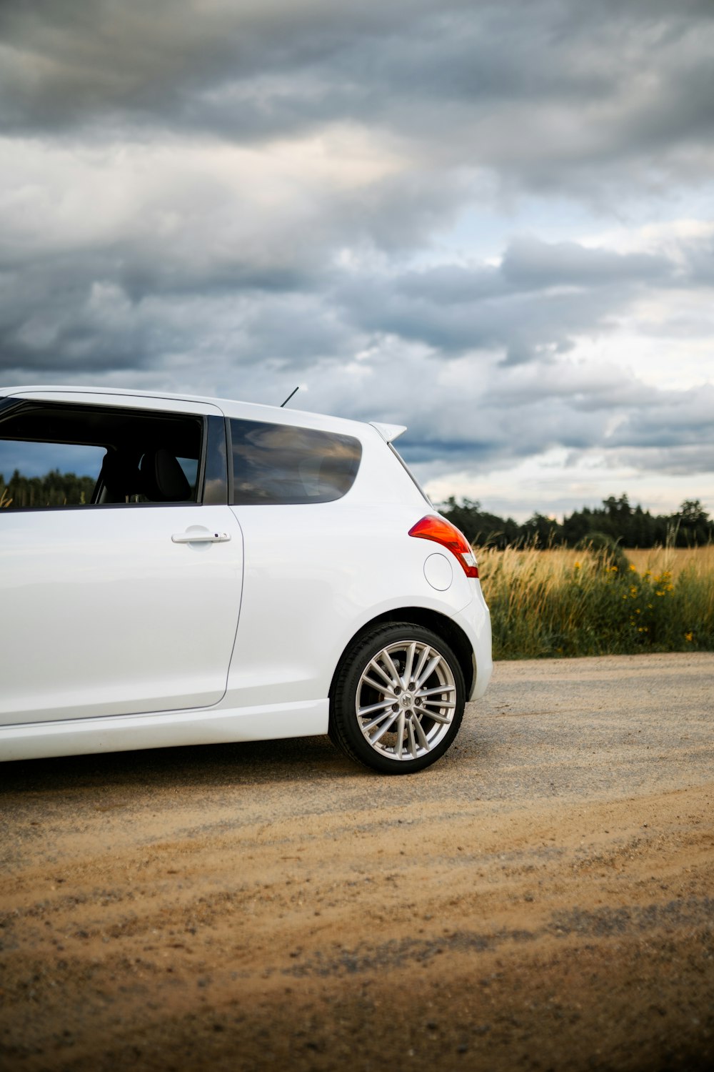 a white car parked on the side of a road