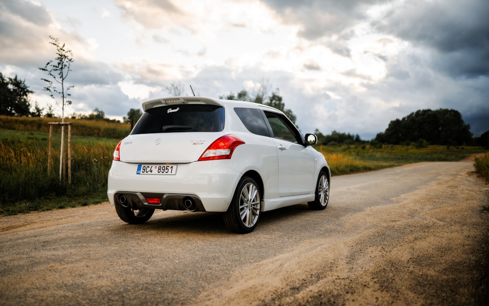 a white car parked on the side of a road