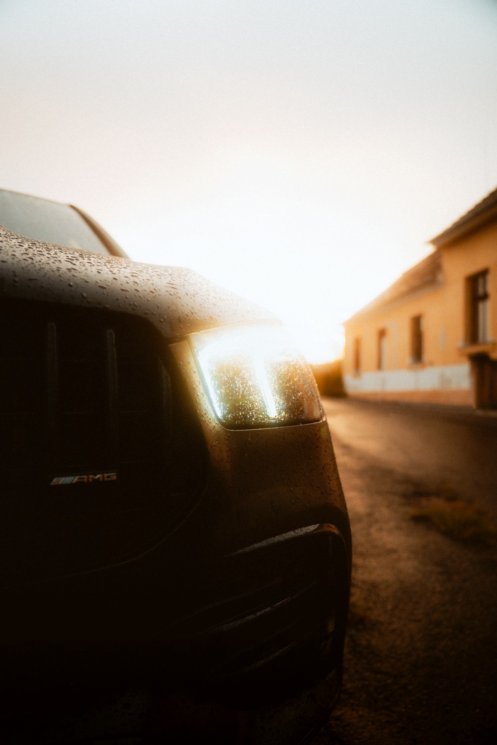 a car parked on the side of a road next to a building