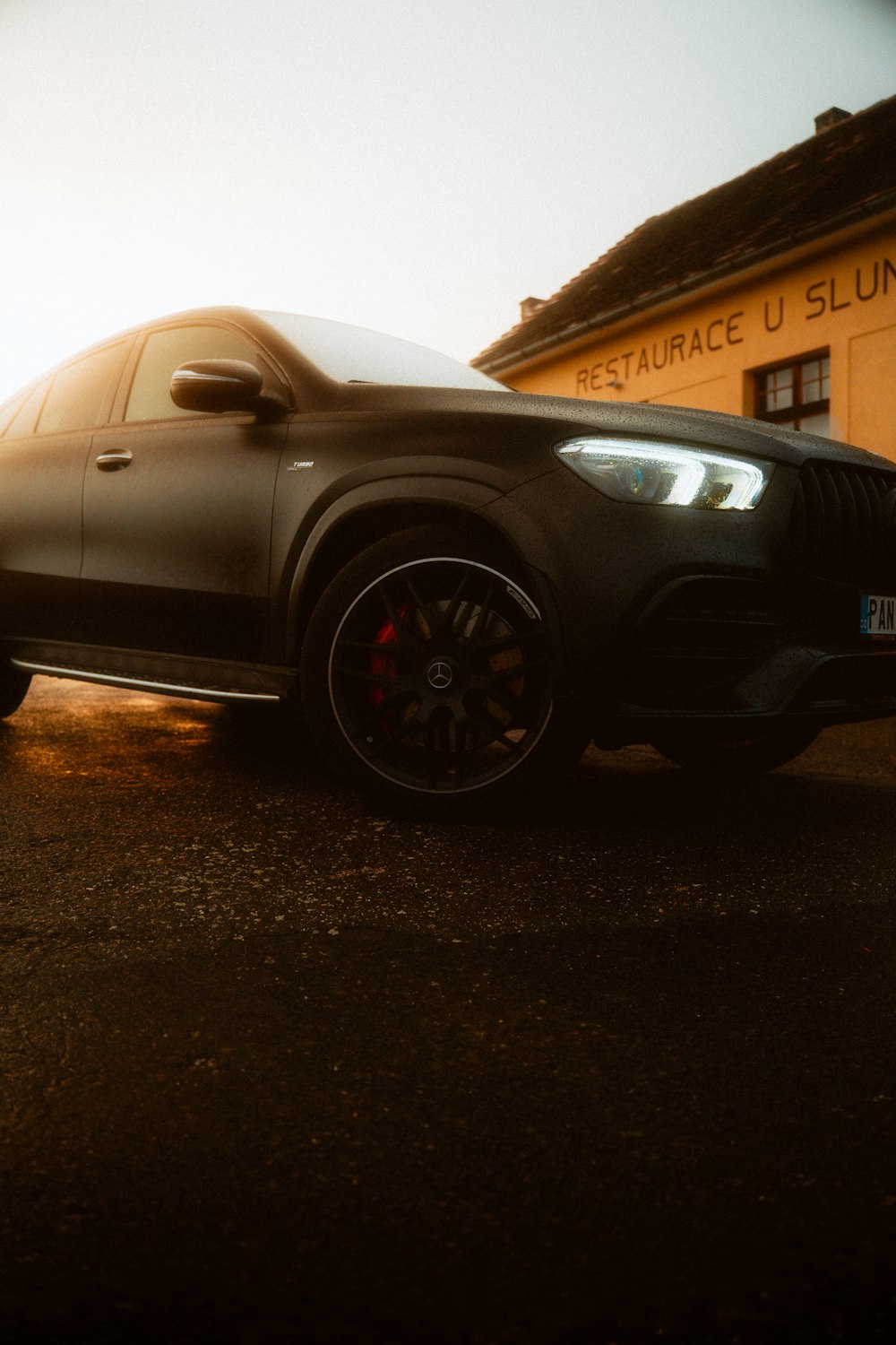 a black car parked in front of a building