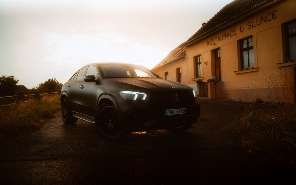 a black car parked in front of a building