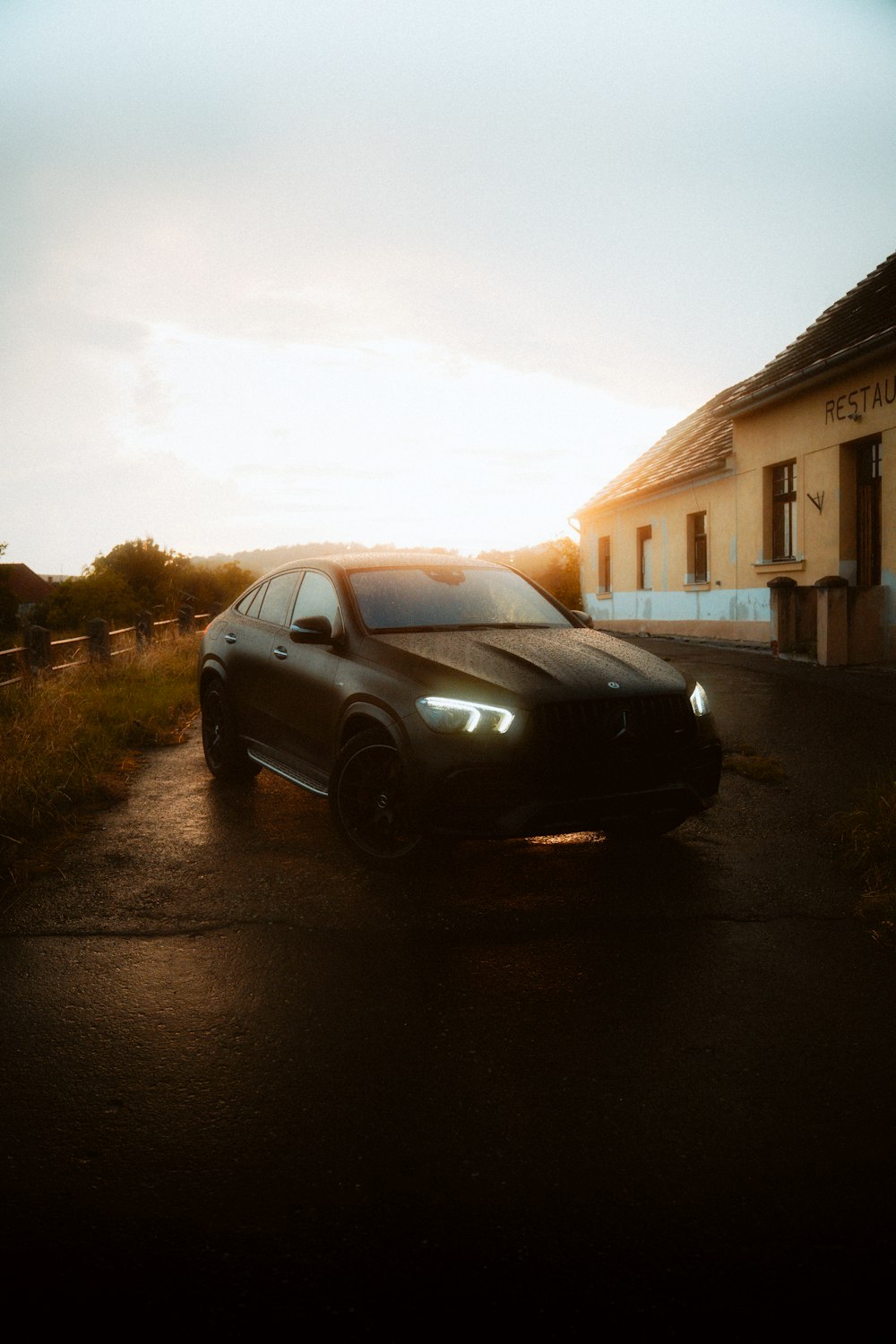 a black car parked in front of a building