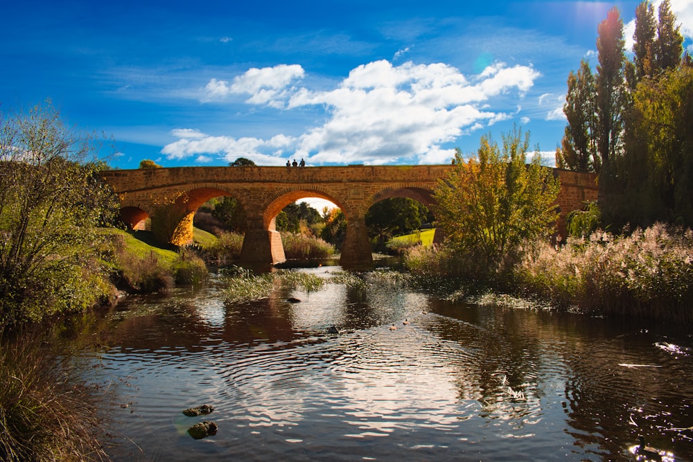 a bridge over a river with a sky background