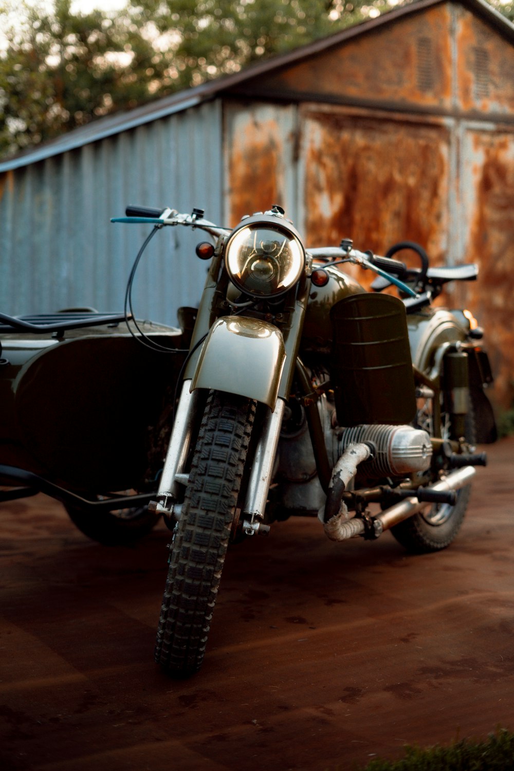 a motorcycle parked in front of a rusted building