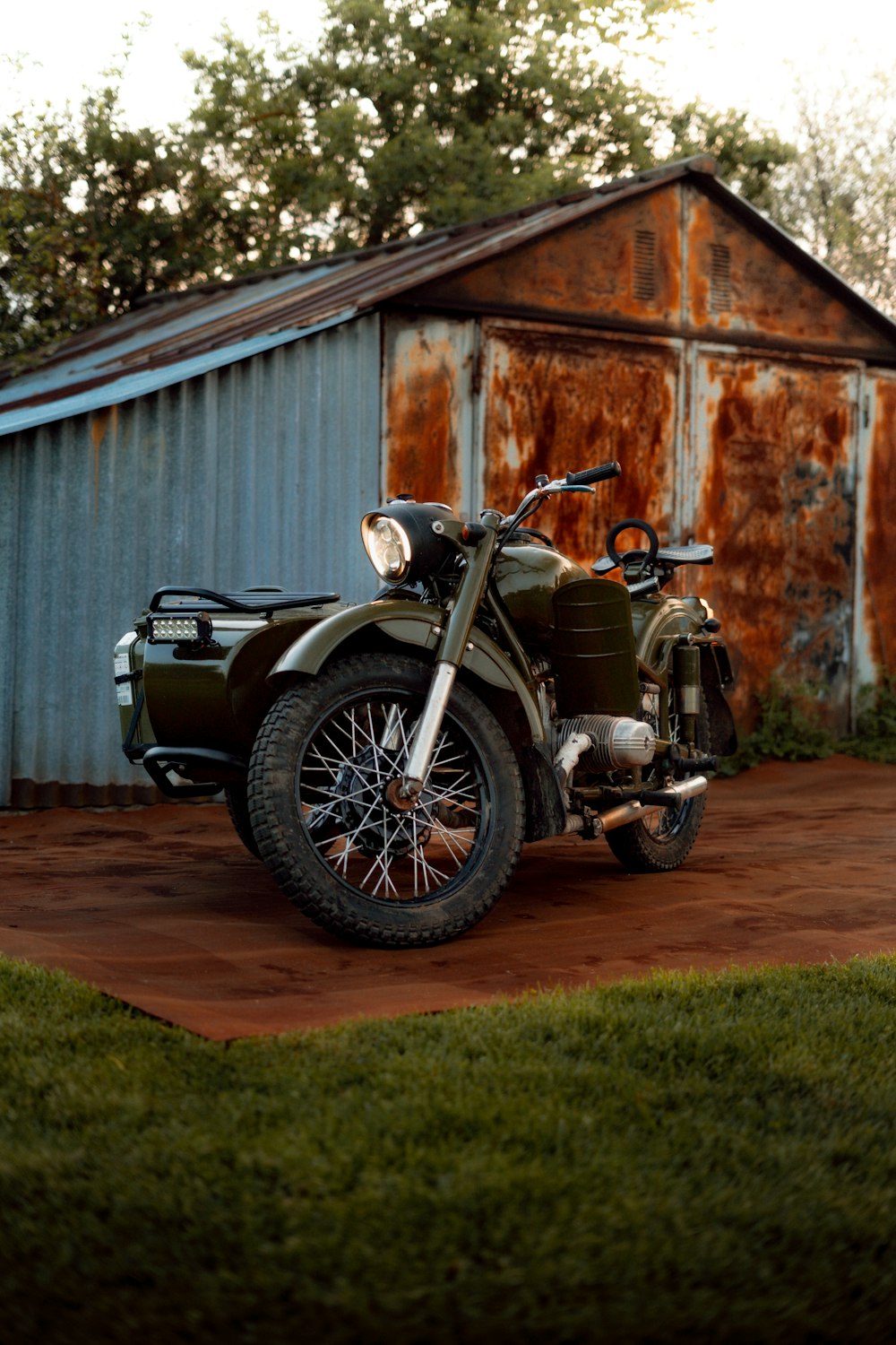 a motorcycle parked in front of a rusted building