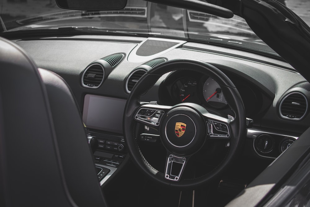 the interior of a car with a steering wheel and dashboard