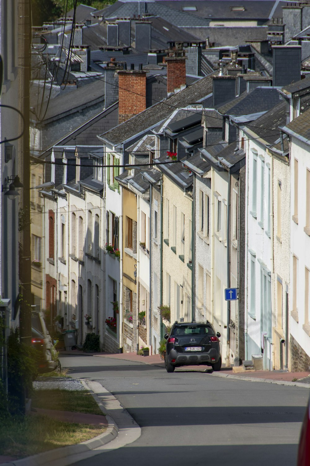 a car driving down a street next to tall buildings