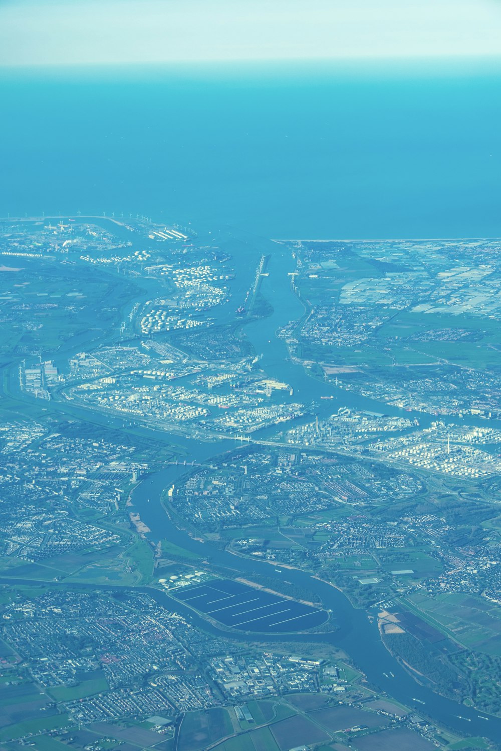 an aerial view of a river running through a city