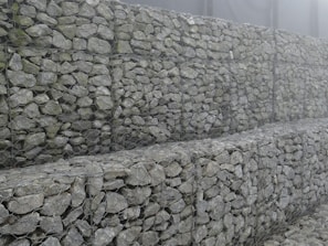 Close-up of a sturdy gabion wall blending with Patagonian mountain scenery.