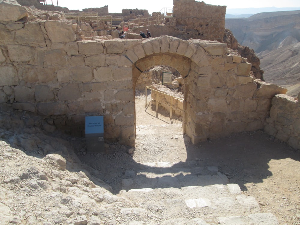 a stone building with a sign in the middle of it