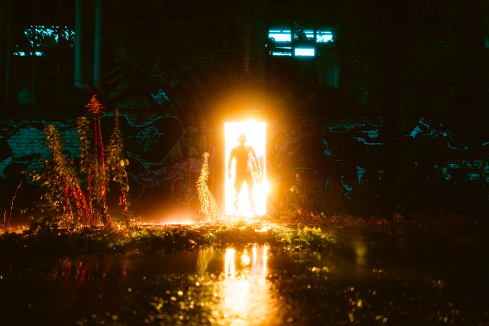 a man standing in a doorway at night