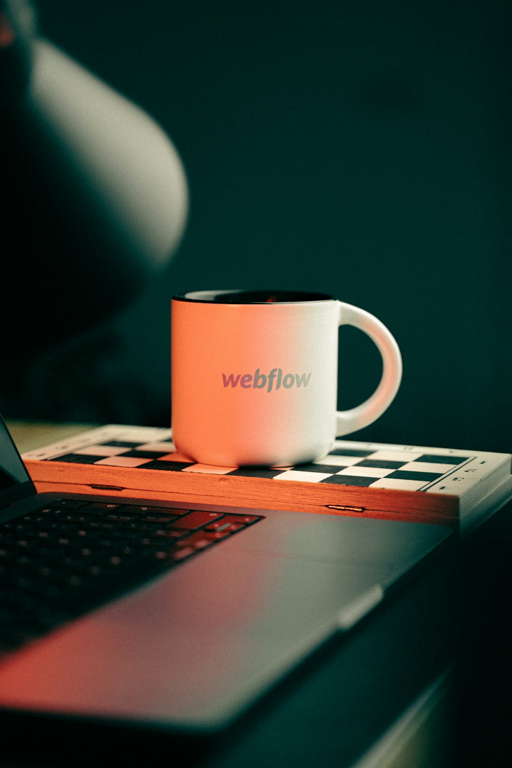 a coffee mug sitting on top of a laptop computer