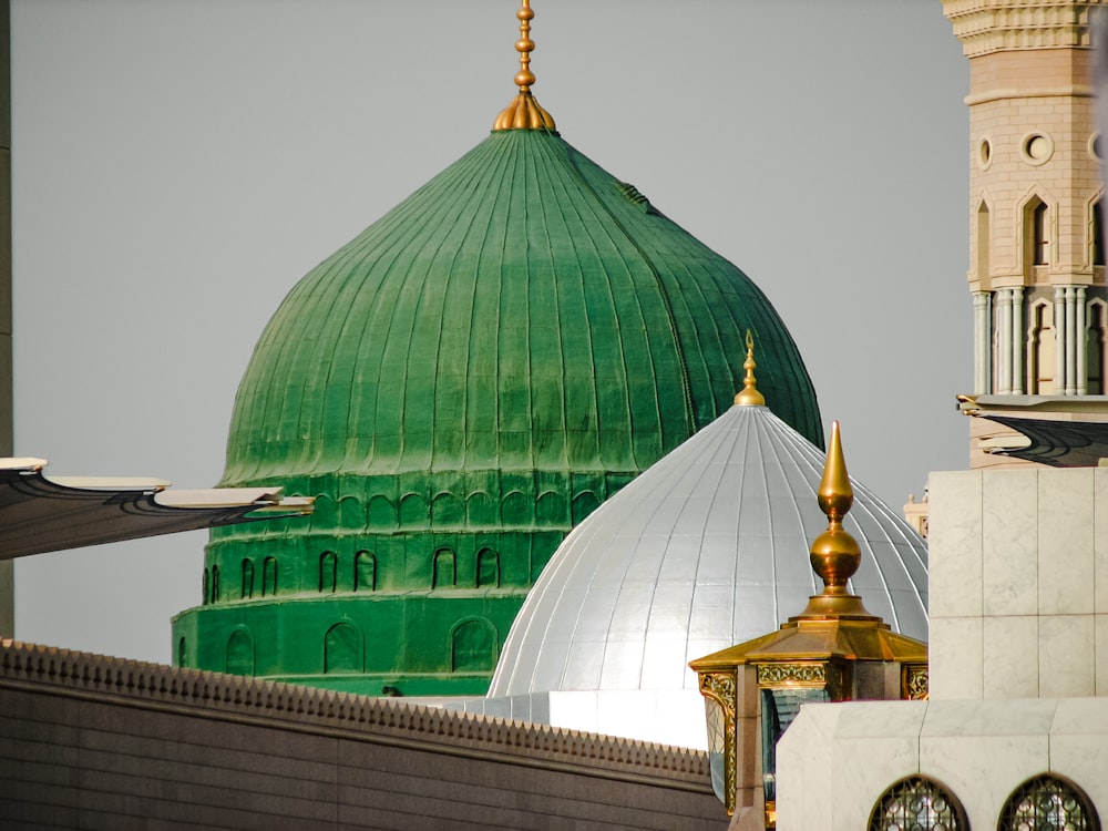 a green dome and a white dome on a building