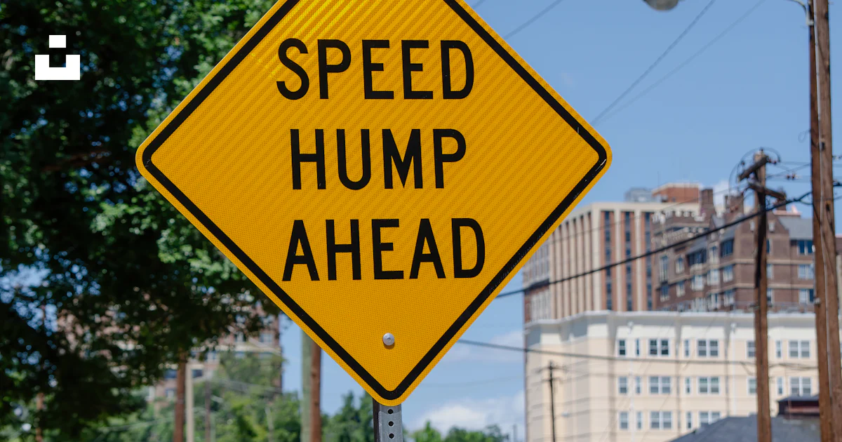 Yellow Rump Sign Road A yellow speed hump sign sitting on the side of a road photo – Free ...