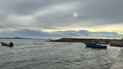 Fishing boats at sea during early morning light.