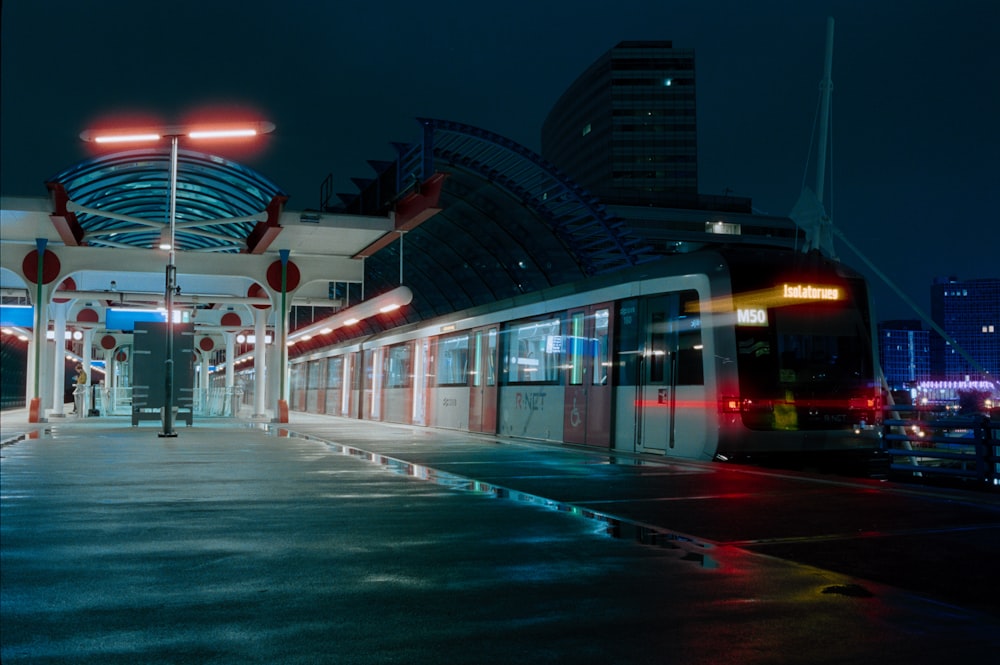 a train pulling into a train station at night