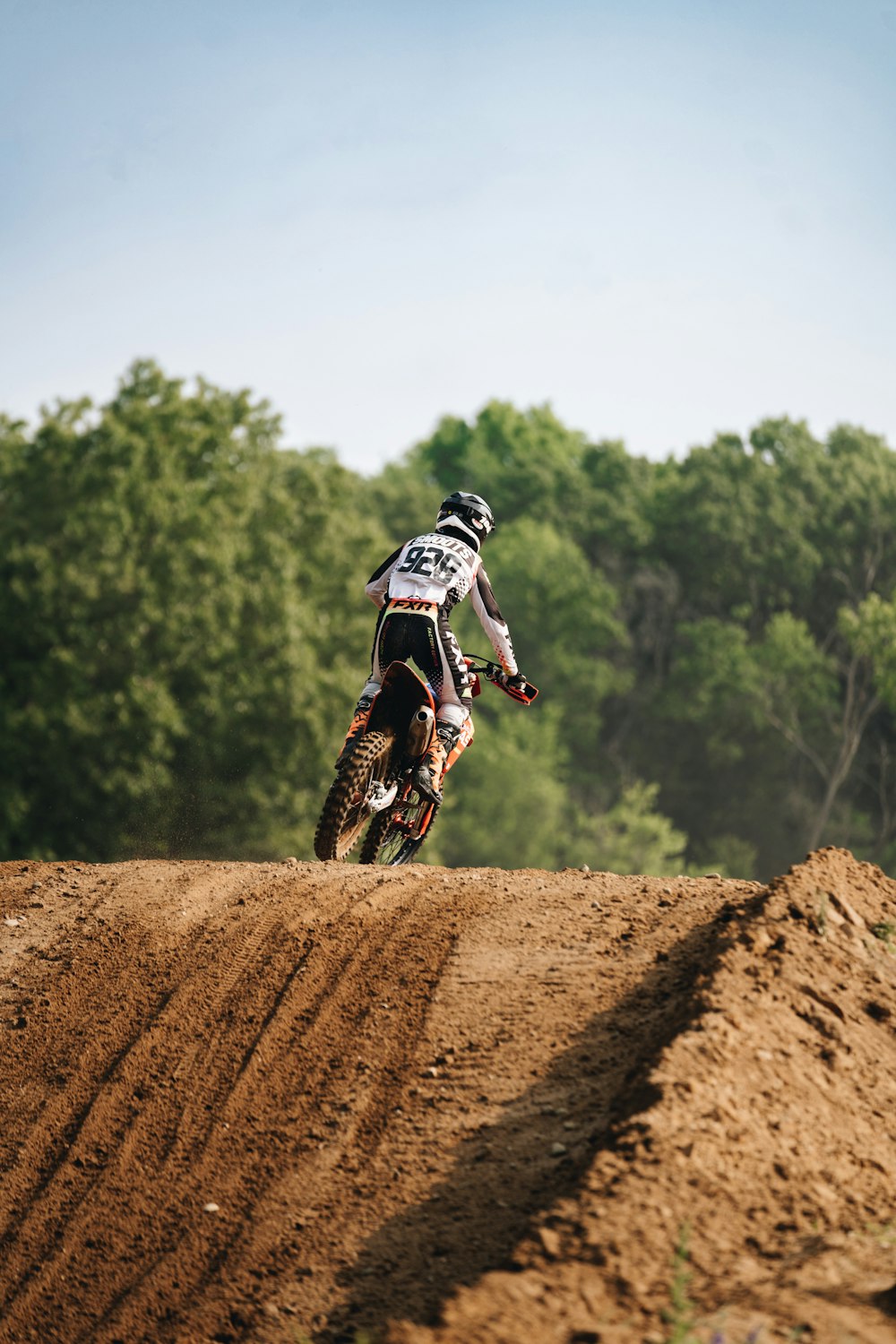 a man riding a dirt bike on top of a dirt field