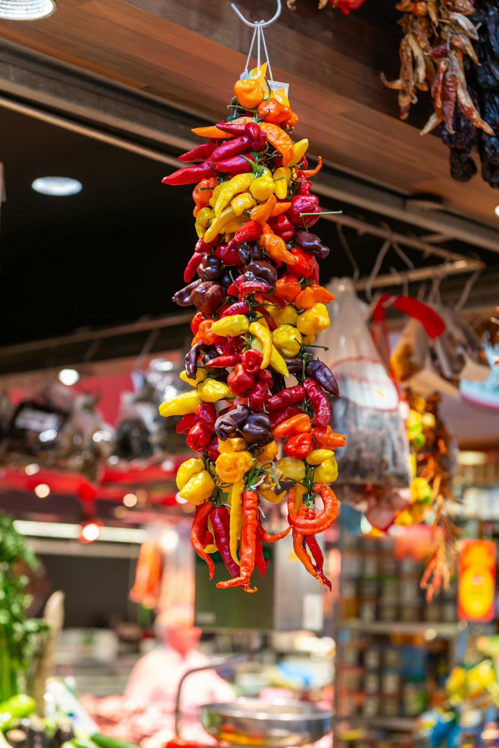 a bunch of peppers hanging from a ceiling