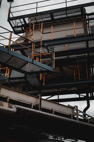 a large metal structure with a clock on top of it