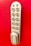 A metallic keypad lock with a vertical arrangement of buttons numbered from one to nine, set against a bright red background. The lock has a modern design with smooth edges and the brand name 'KitLock' displayed prominently at the bottom. The buttons have a beige color with black numbers on them.