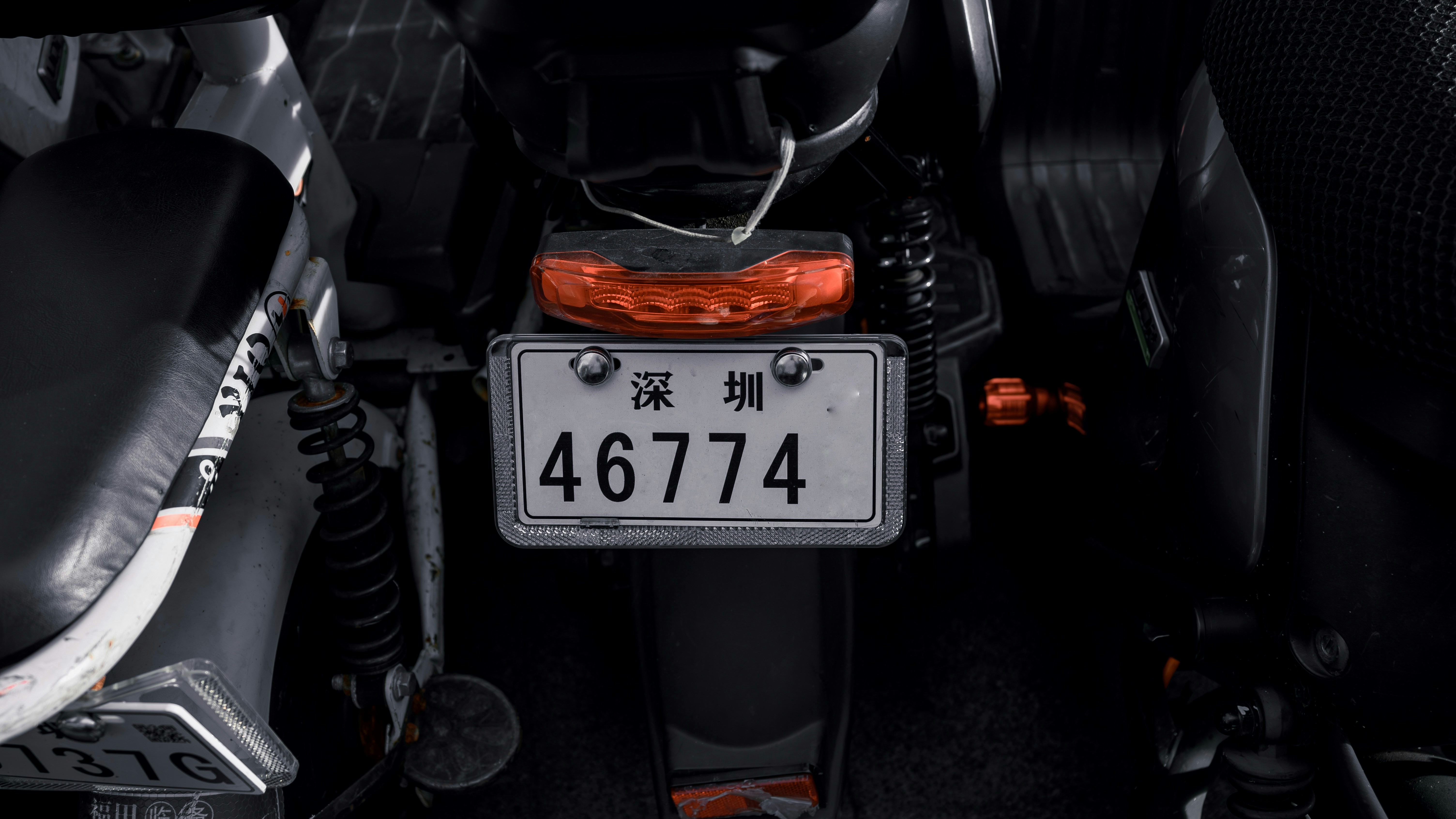 a close up of a motorcycle with a number plate