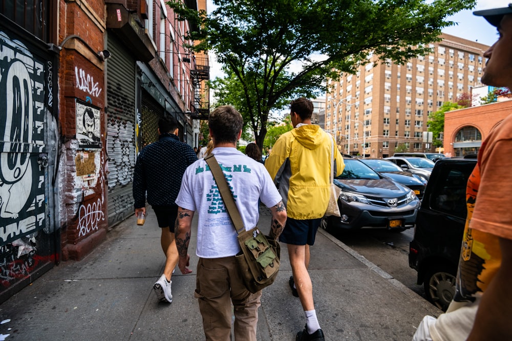 a group of people walking down a sidewalk