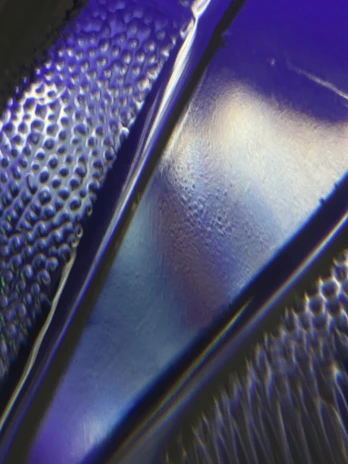 Detail of a polyurea floor coating with a vibrant blue finish and seamless texture.