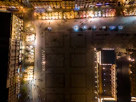 Night view of a city square illuminated by street lamps and neon signs.