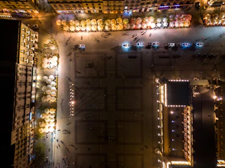 Night view of a city square illuminated by street lamps and neon signs.