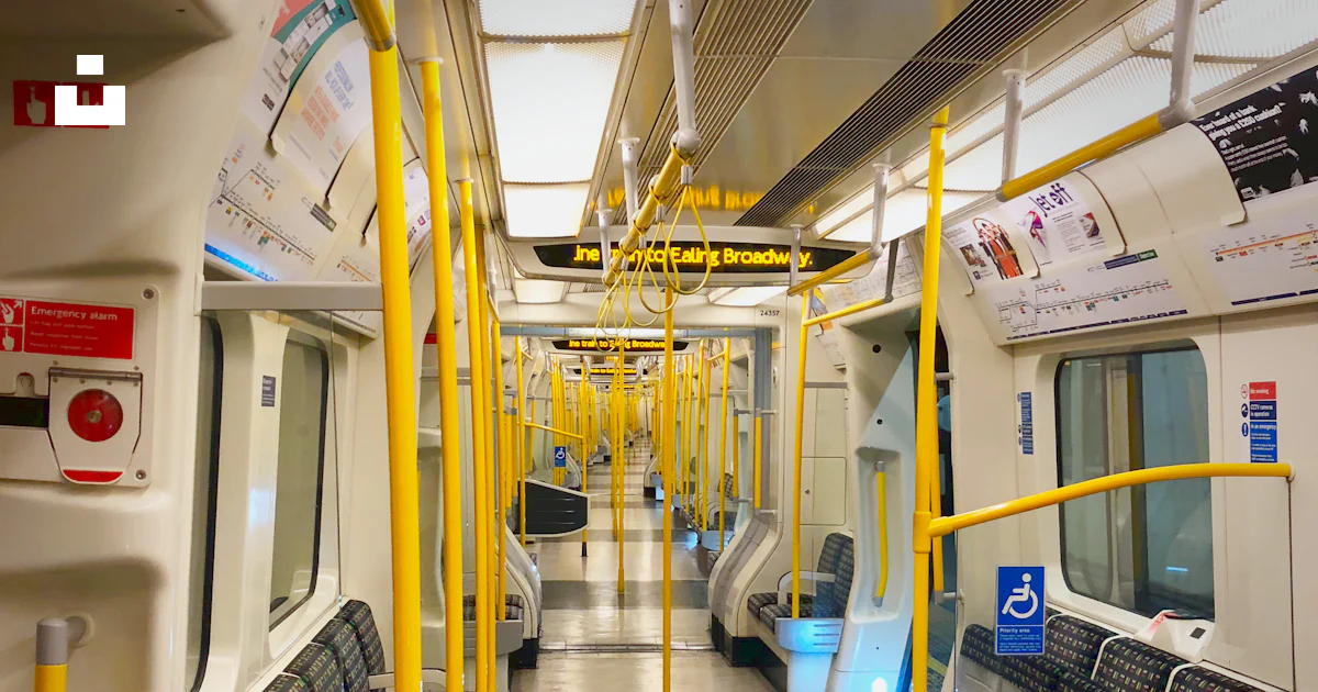 A subway car with yellow railings and seats photo – Free Tube Image on ...