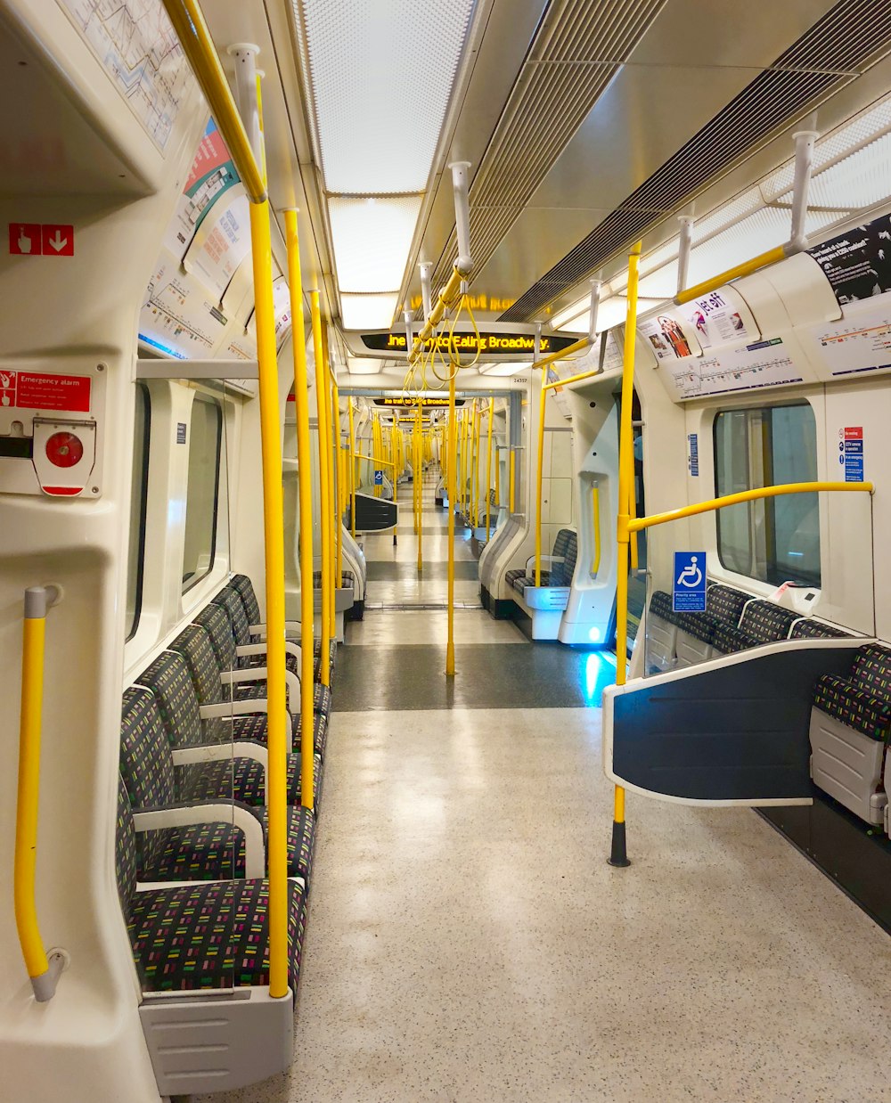 a subway car with yellow railings and seats