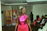 A smiling young woman confidently walking the runway during a fashion workshop.