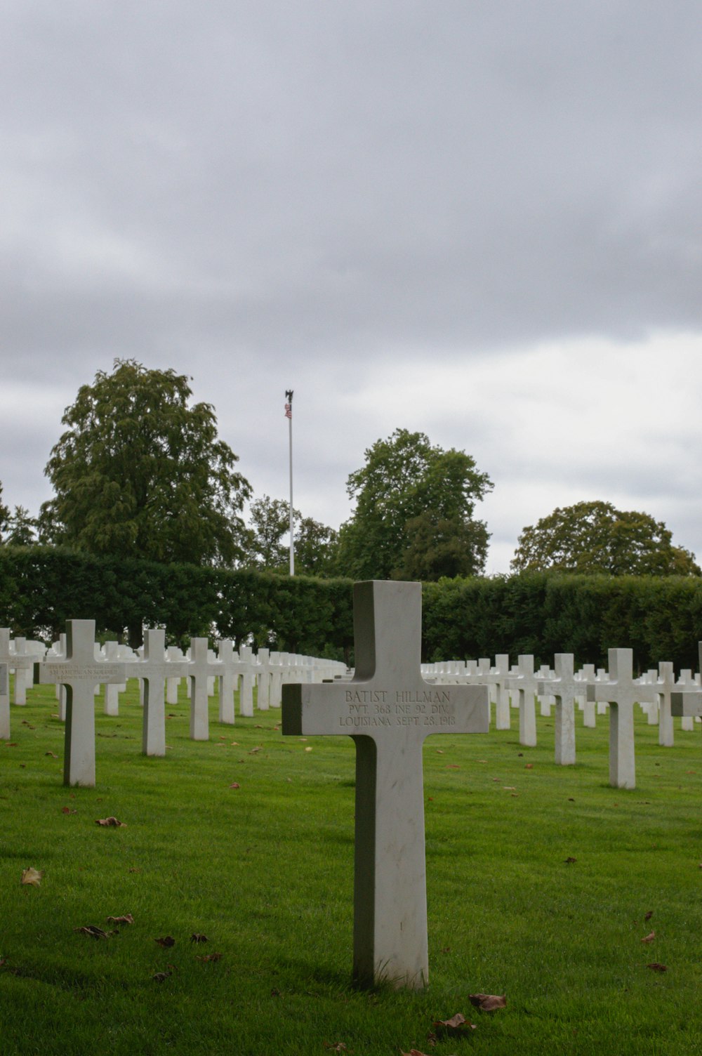 a cemetery with a cross in the middle of it