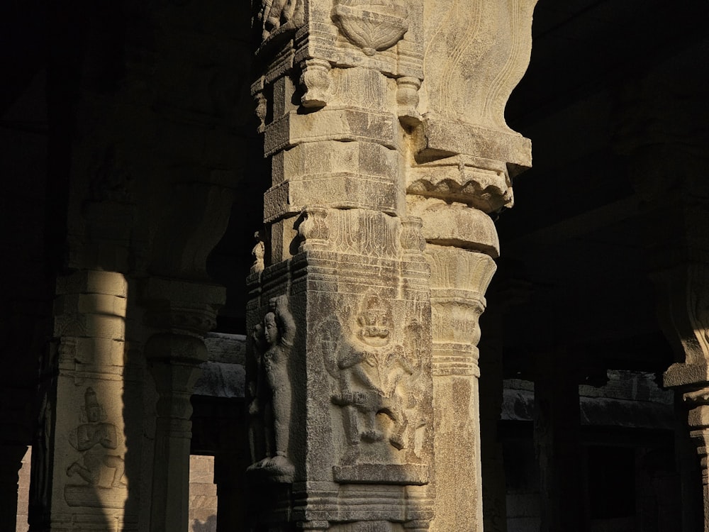 a close up of a stone pillar with carvings on it