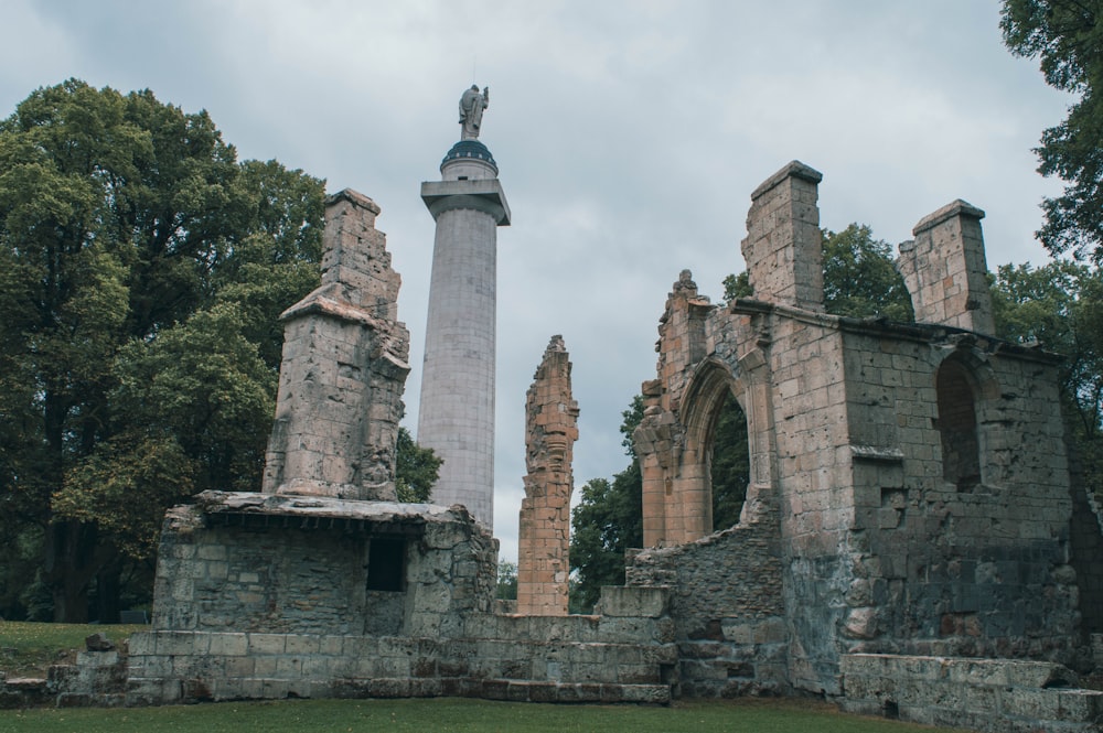 an old stone building with a statue on top of it