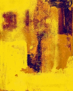 An abstract painting featuring bold, textured strokes of yellow and deep maroon colors. The brushwork is rough and expressive, offering a sense of dynamic movement and depth. The composition is dominated by vertical and horizontal areas of color with layered textures.