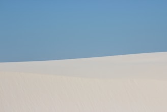 A picturesque scene of the white sands of Farafra under a clear blue sky.